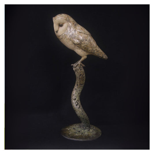 Bronze owl sculpture on a dark background