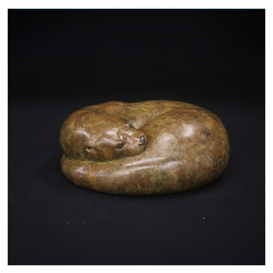 Bronze sculpture of a bear on a black background