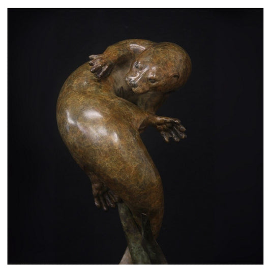 Bronze sculpture of a bear on a black background