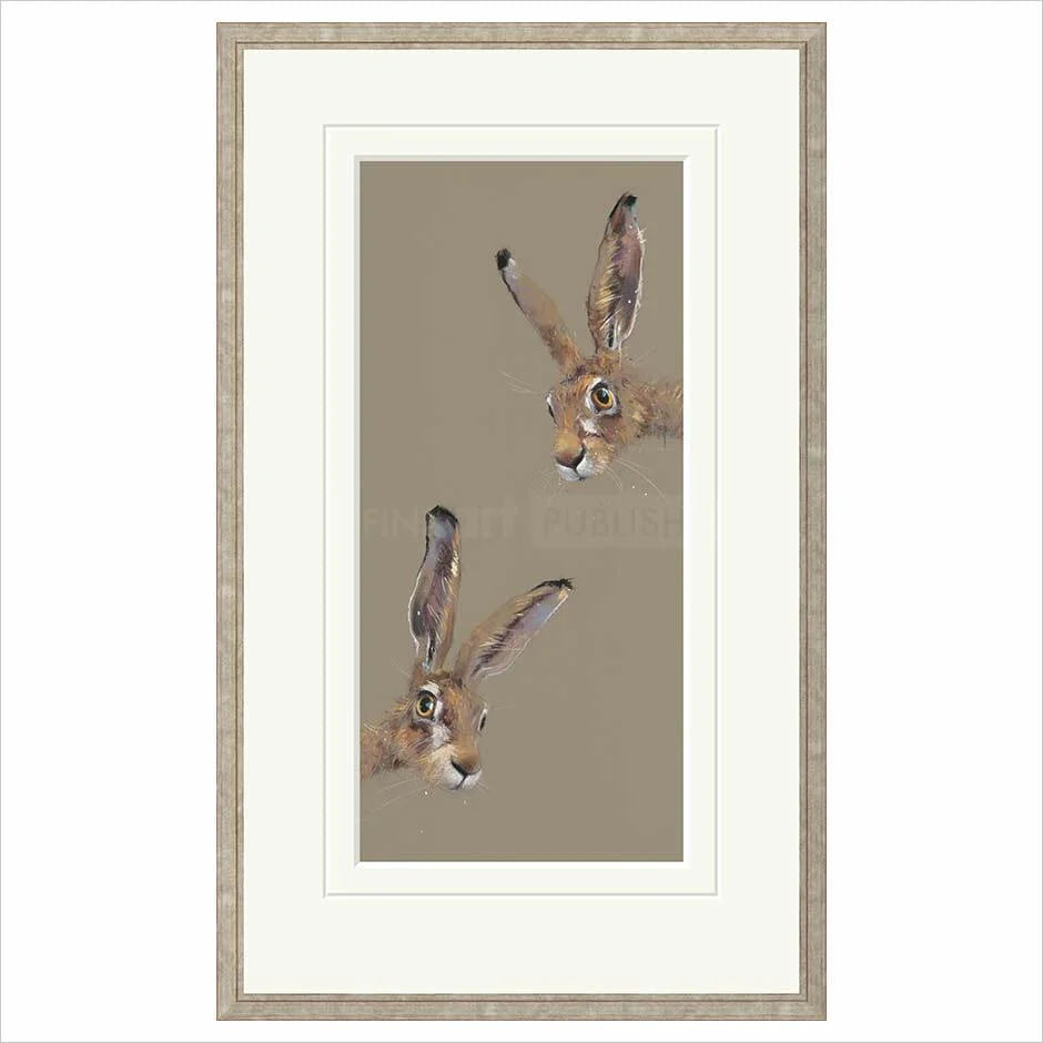Framed artwork of two hares on a beige background