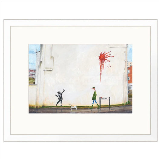 Framed artwork of a street scene with a child playing and a person walking a dog, featuring a red splash on a wall.