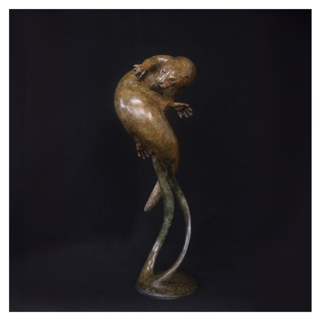 Bronze sculpture of a frog on a black background