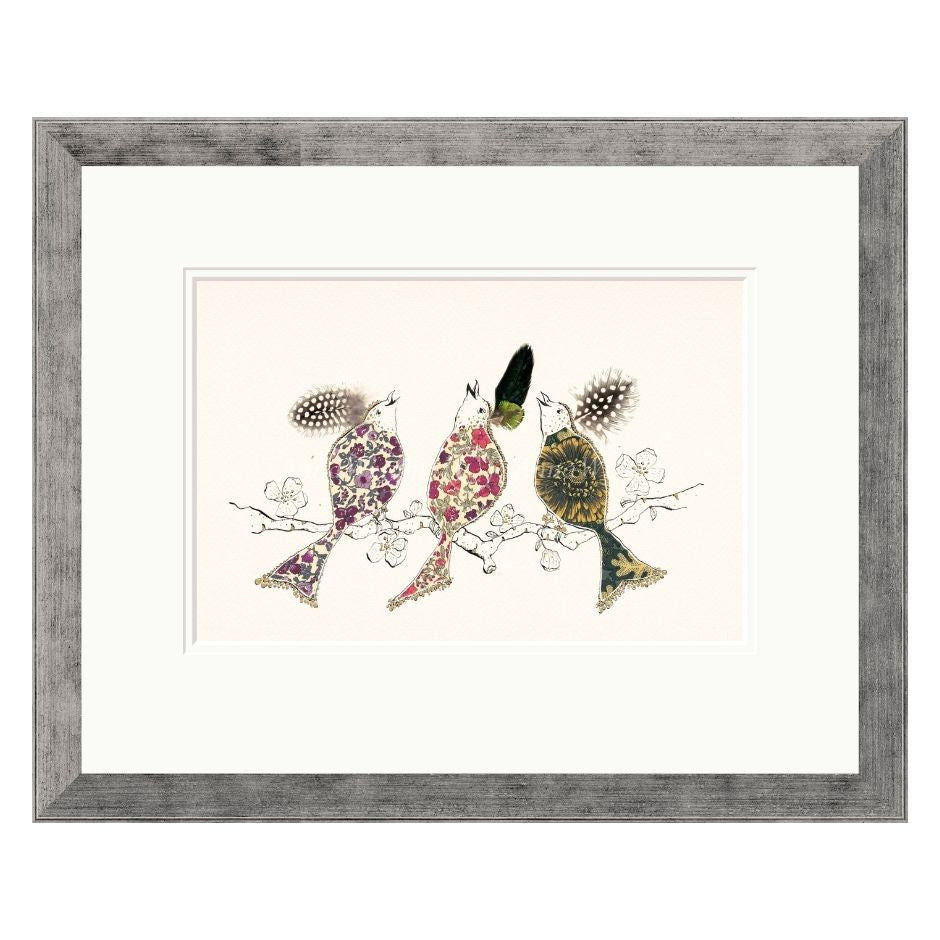 Framed artwork of three stylized birds on a branch with a decorative frame.