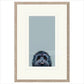 Framed artwork of a dog's face on a light blue background