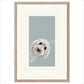 Framed artwork of a dog's face on a light blue background