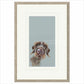 Framed artwork of a dog's face on a light blue background
