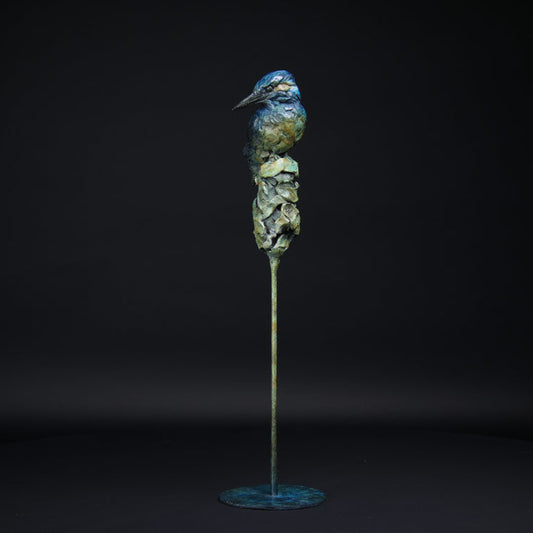 Bronze sculpture of a kingfisher on a black background