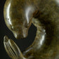 Bronze sculpture of a seal on a dark background